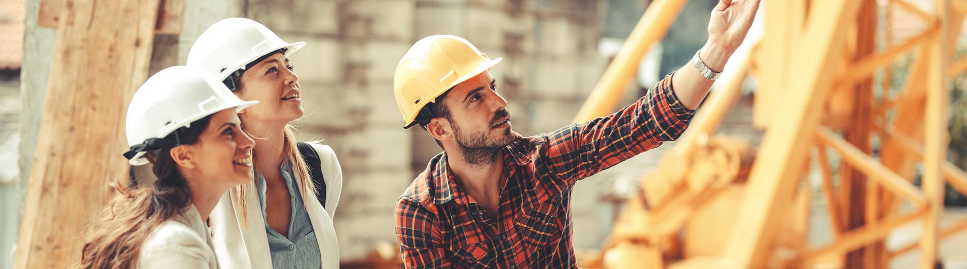 Photo de deux femmes qui visite un chantier avec une présentation faite par un homme qui montre l'avancement